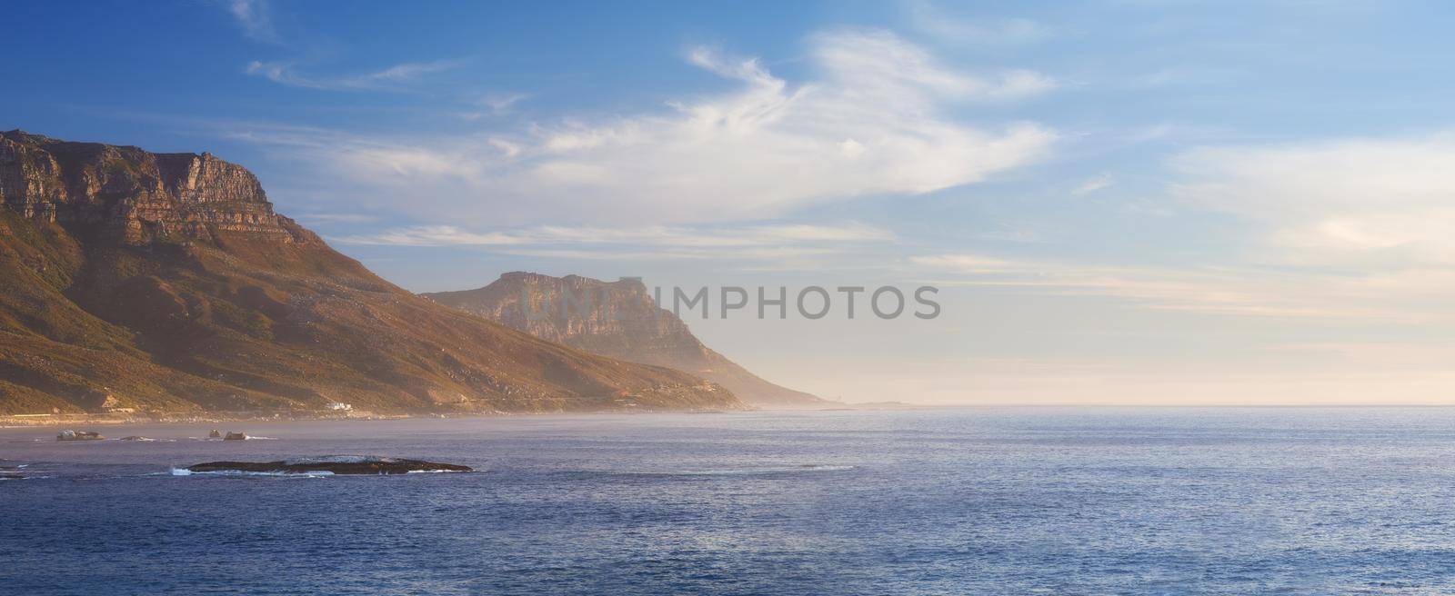 Land and sea. A view of a picturesque mountain meeting a oceanic bay