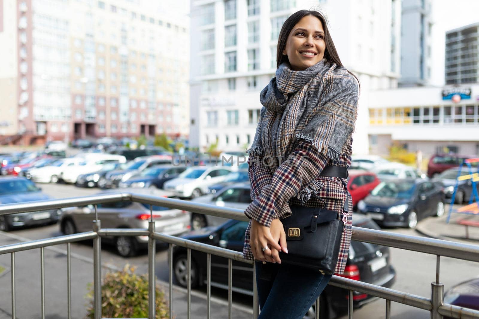 portrait of a young happy woman on the background of the city with a smile on her face.