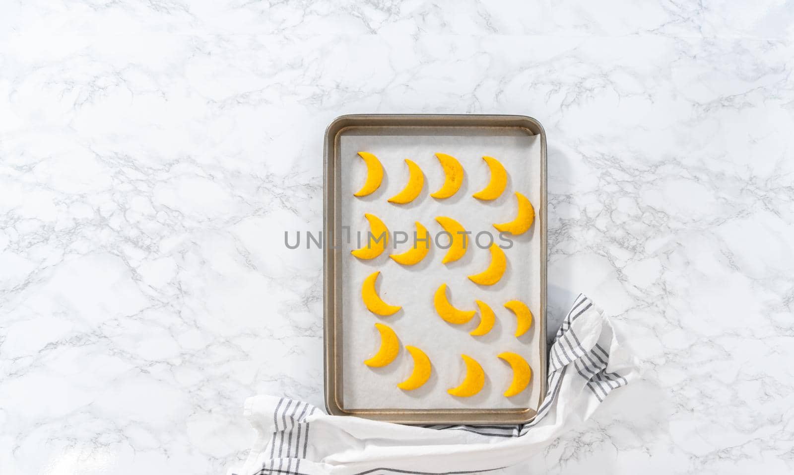 Flat lay. Lemon wedge cookies with lemon glaze. Cooling freshly baked lemon wedge cookies on a kitchen counter.