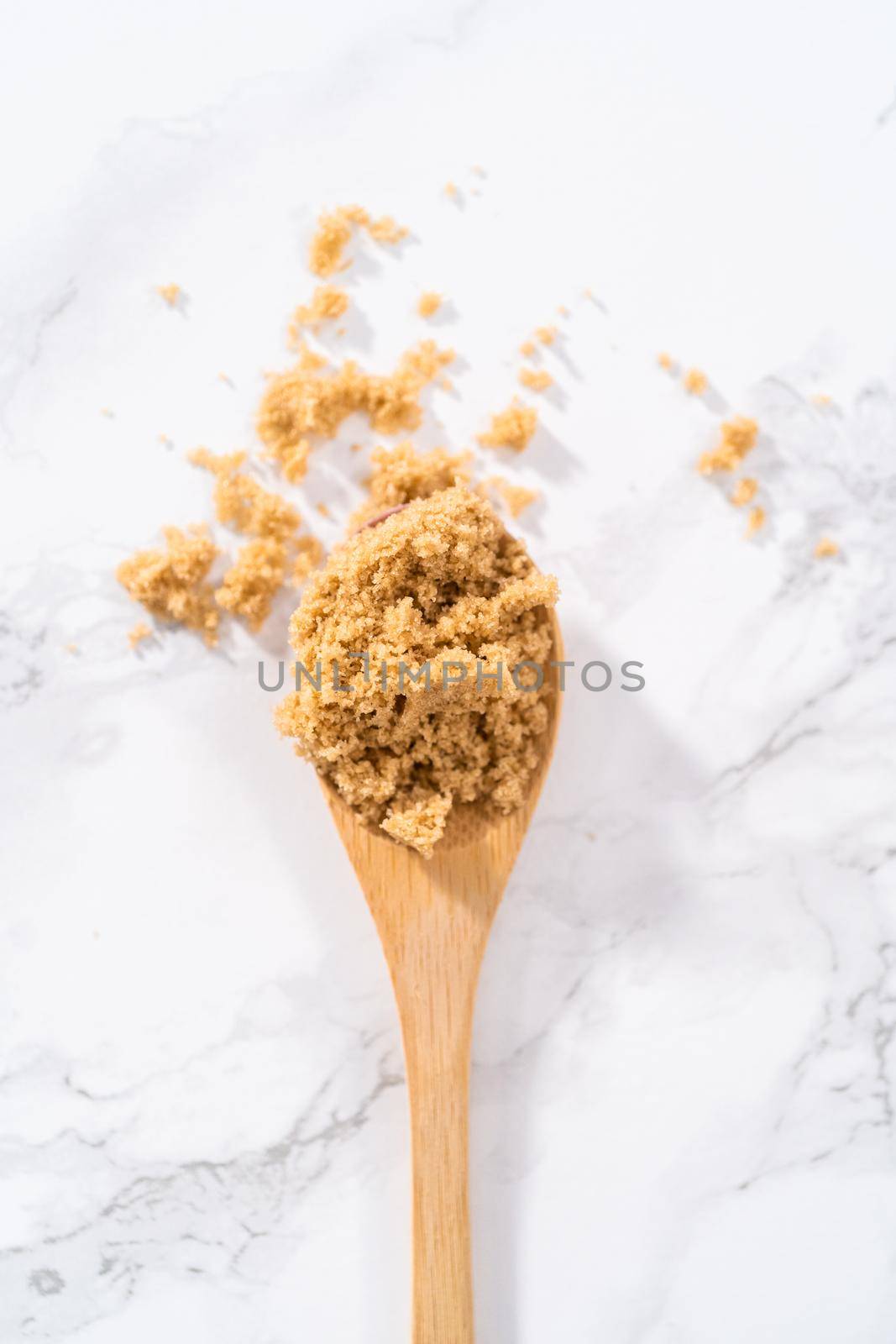 Light brown sugar on a marble counter top.