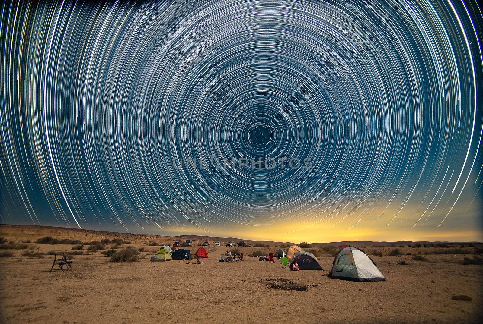 Star trails over noght desert camp by javax