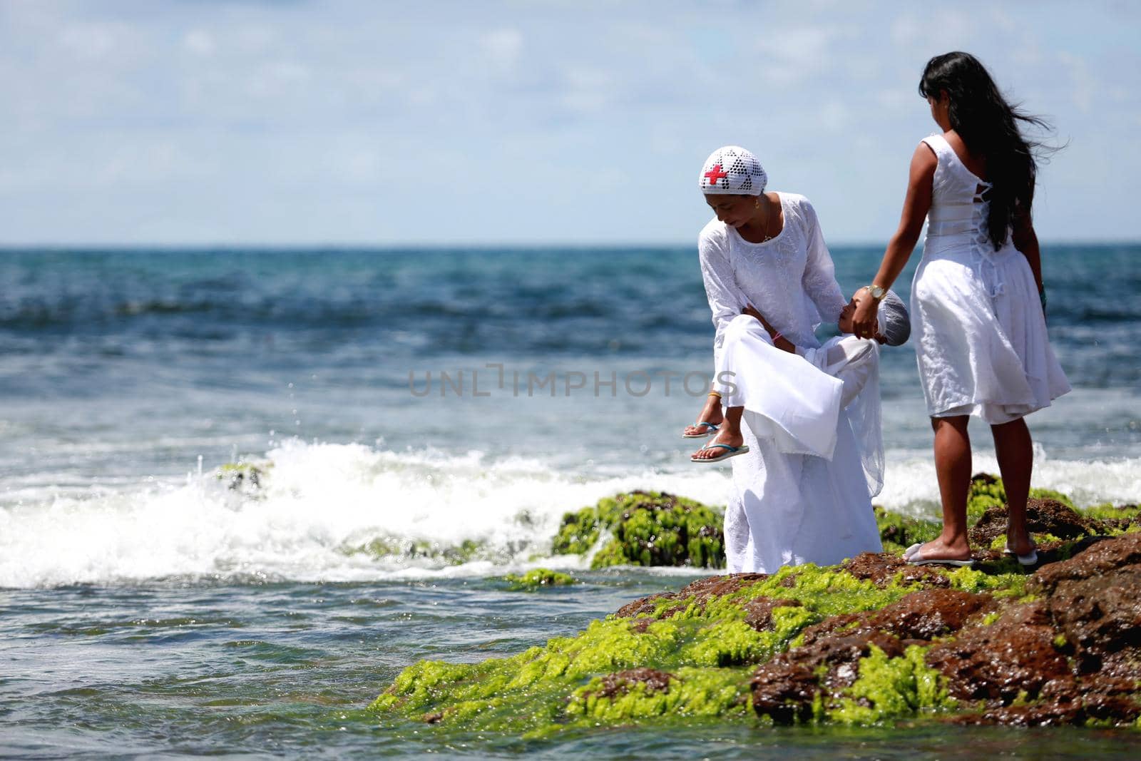 salvador, bahia / brazil - february 2, 2015: supporters of candomble are seen on the Rio Vermelho beach in the city of Salvador during a party in honor of Yemanja.