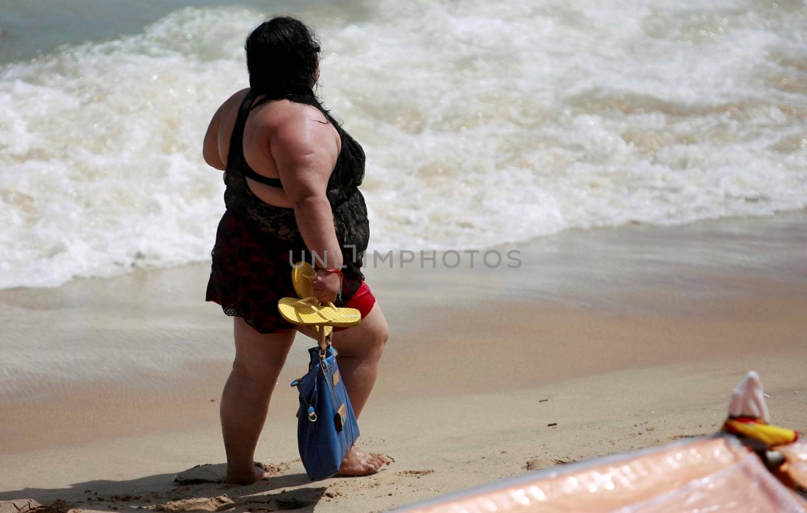 salvador, bahia / brazil - february 17, 2015: fat woman is seen on Itapua beach in the city of Salvador.