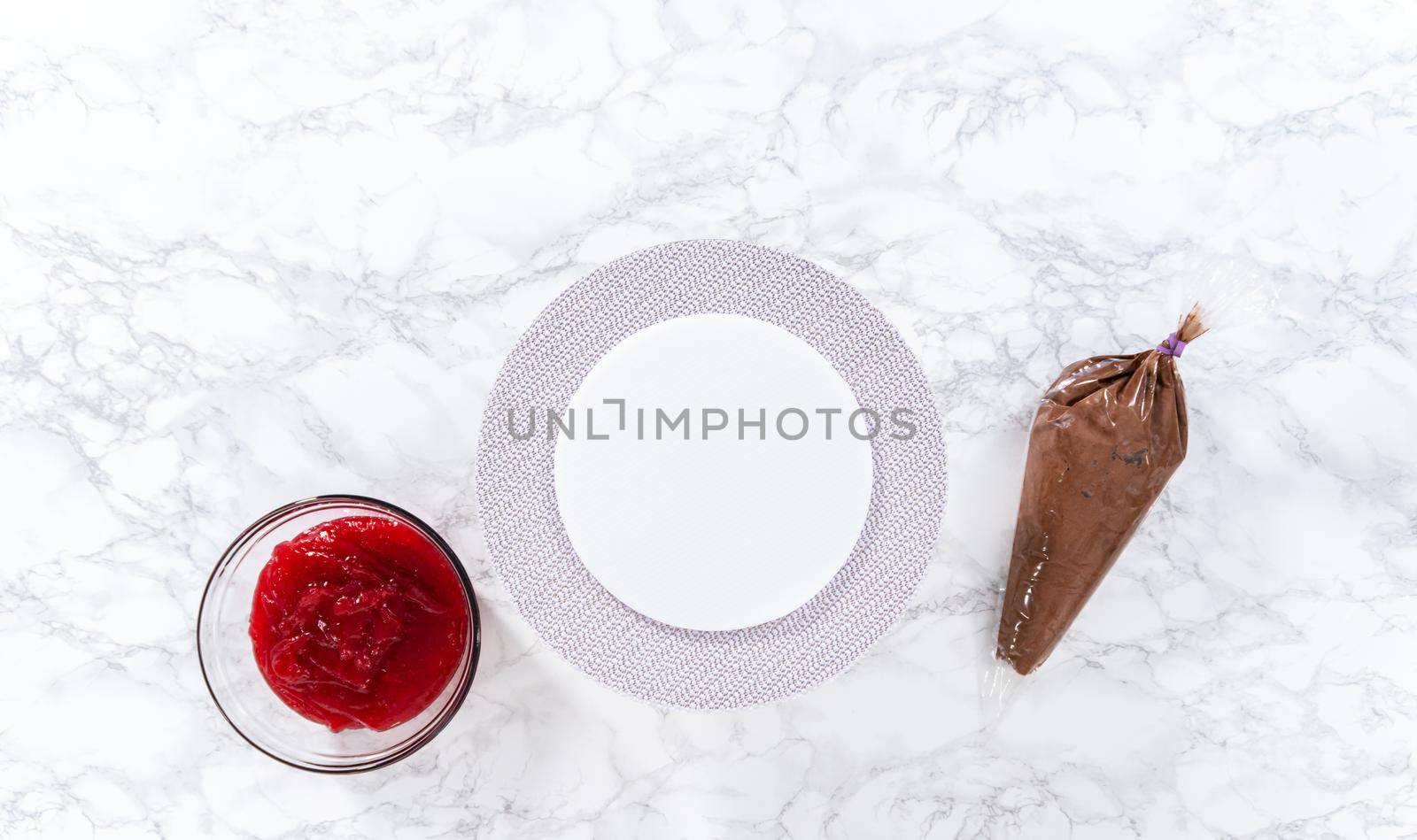 Flat lay. Covering chocolate cake with a crumb layer of chocolate buttercream frosting.