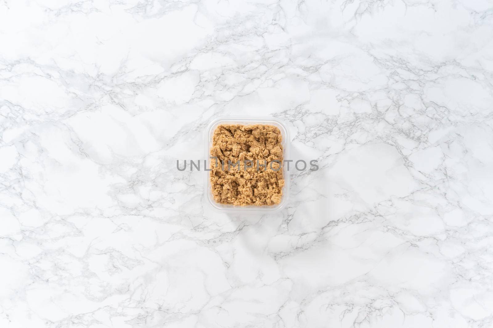 Flat lay. Light brown sugar on a marble counter top.
