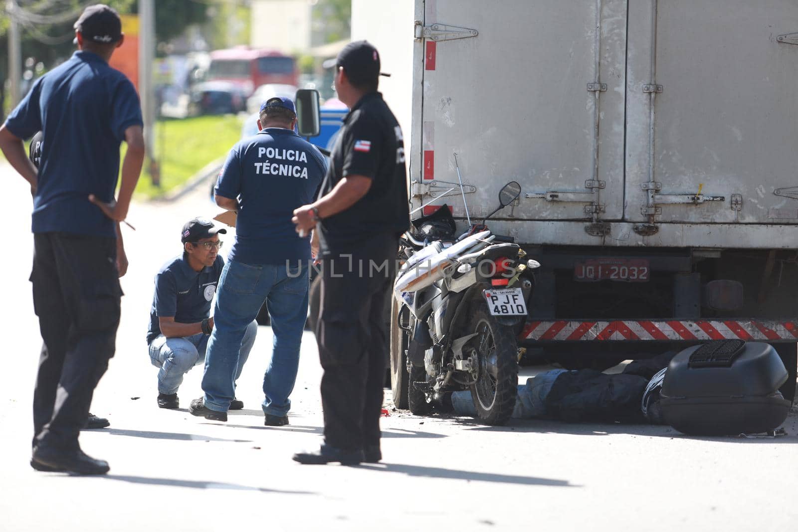 salvador, bahia / brazil - june 18, 2015: Technical Police forensic in traffic accident on Luiz Viana Avenue in Salvador. A man died while colliding a motorcycle in the bottom of a truck.