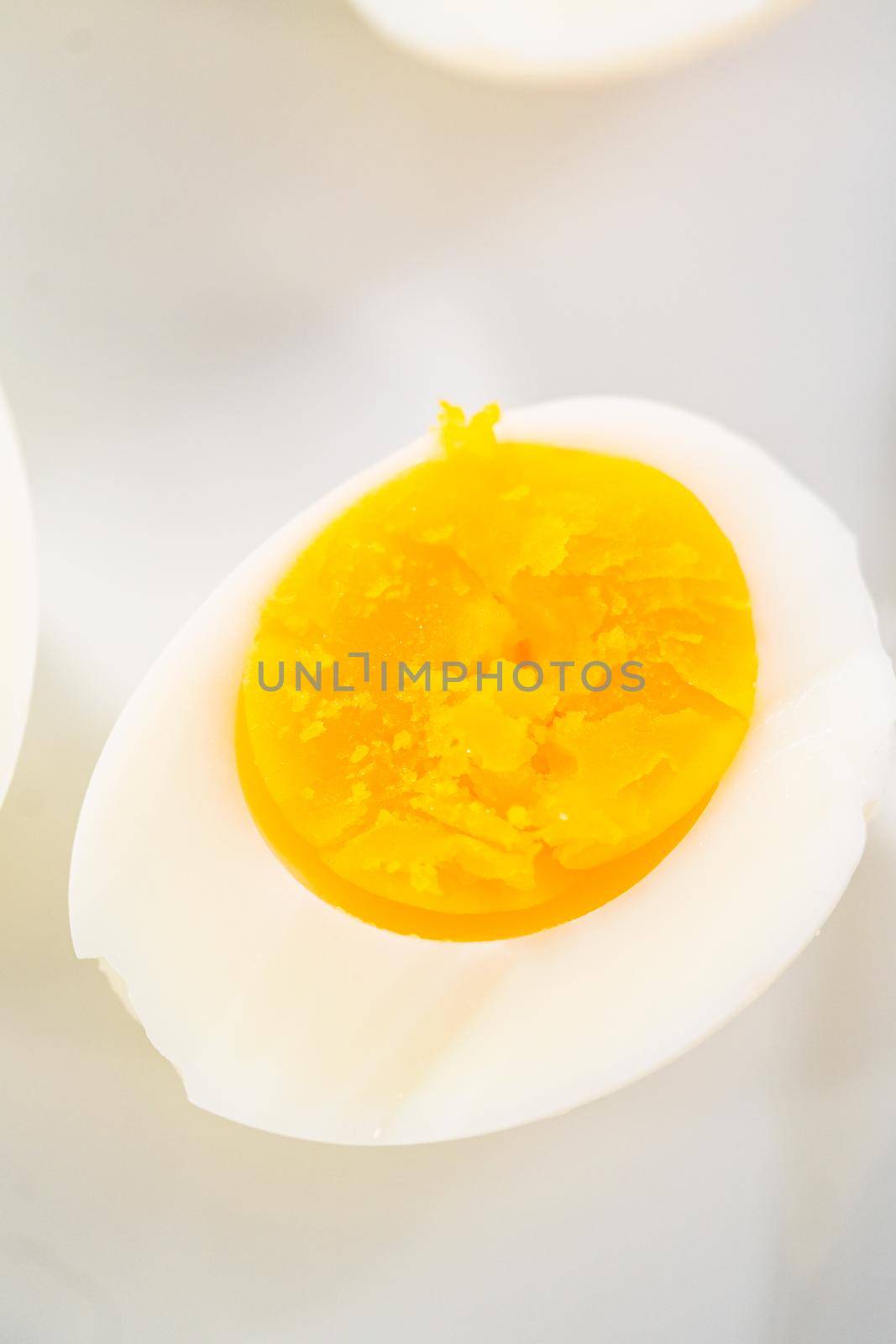 Sliced hard-boiled eggs on a white serving plate.