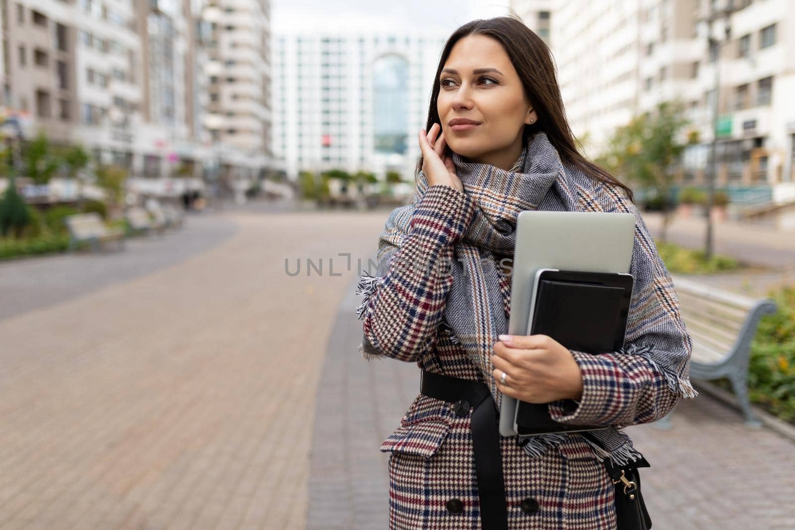 young business woman in a hurry on business with a laptop in her hands.