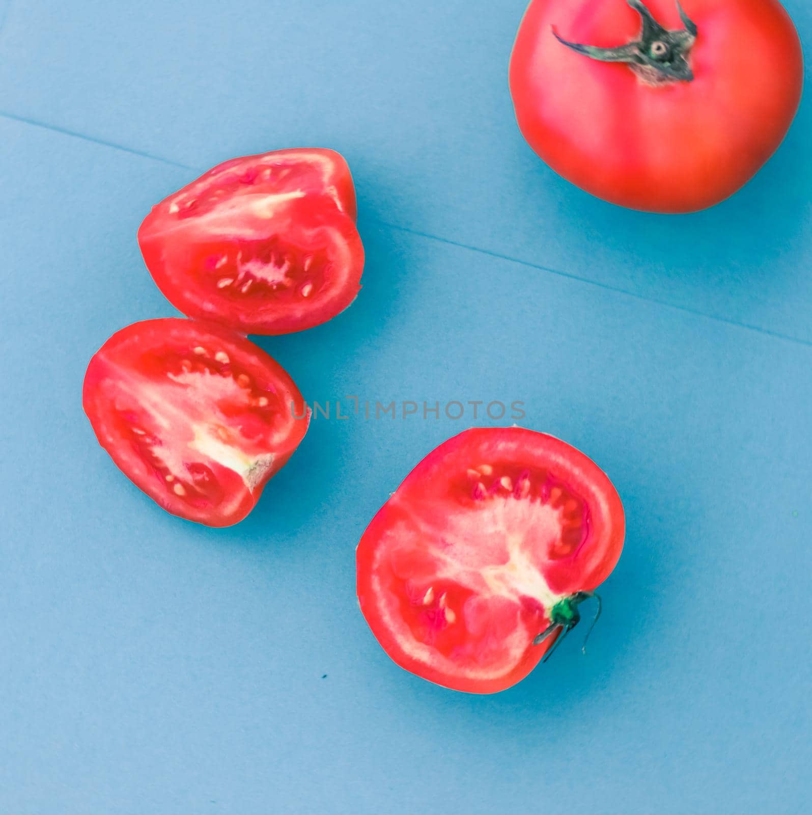 Plant based diet, vegetarian recipe and farm garden concept - Fresh ripe red tomatoes on blue background, organic vegetable food