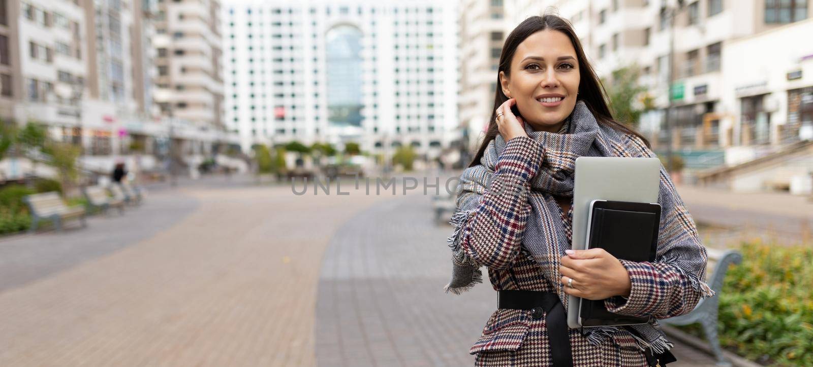 portrait of a successful woman entrepreneur on the background of a residential area.