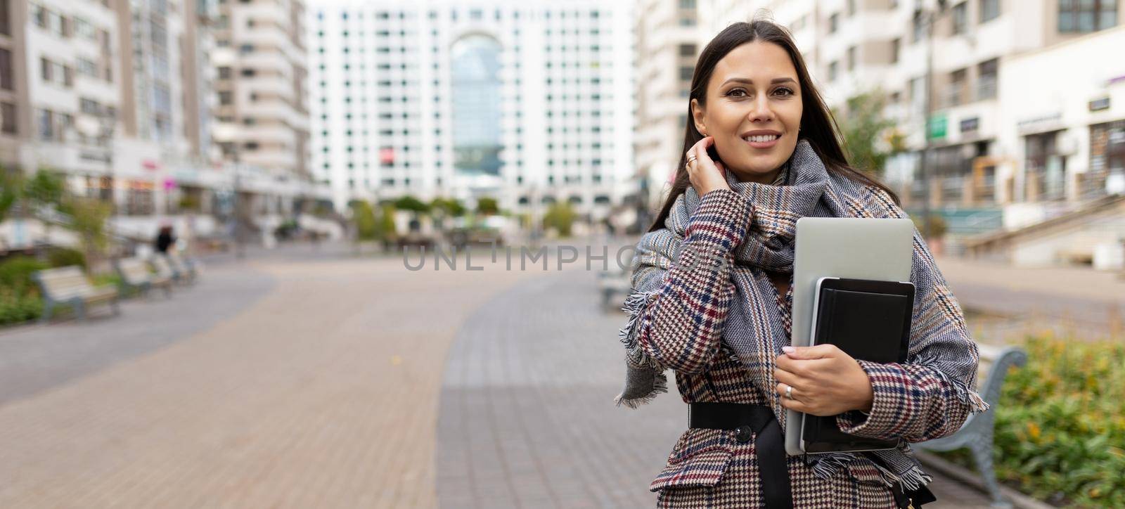 portrait of a successful woman entrepreneur on the background of a residential area by TRMK