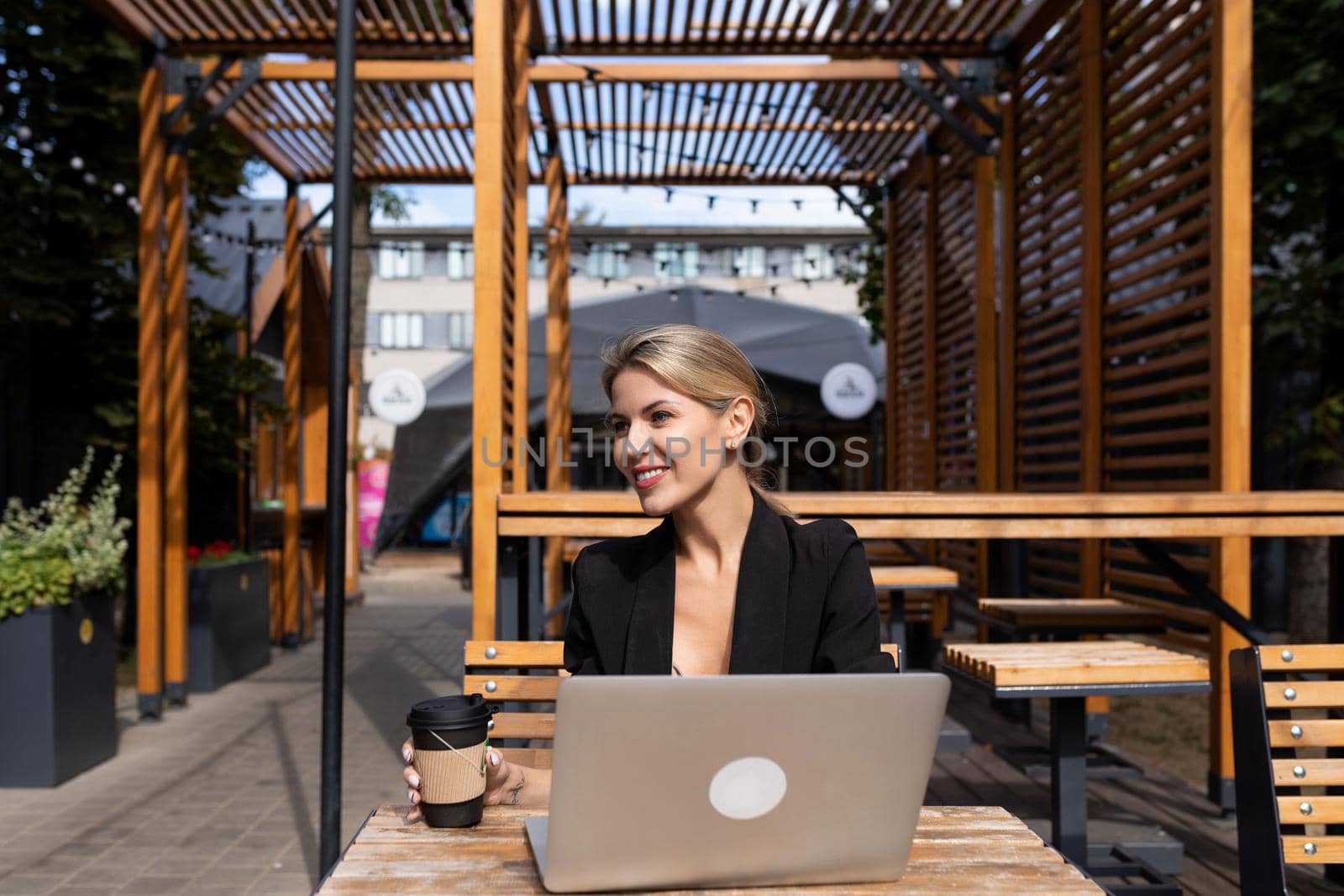 portrait of young successful woman with laptop outdoors.