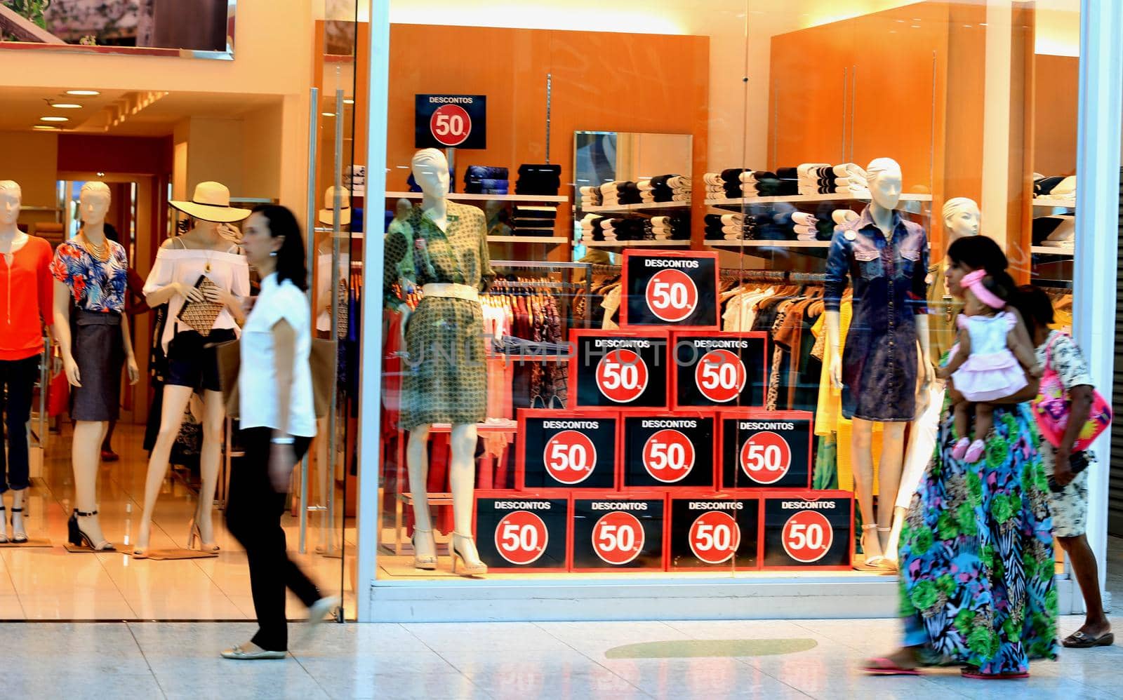 salvador, bahia / brazil - october 21, 2015: poster announcing a 50% discount in a store window in the city of Salvador.
