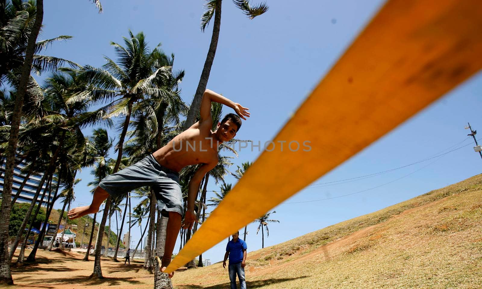 salvador, bahia / brazil  - november 4, 2015: Young man is seen practicing slegline in the Barra neighborhood in Salvador.