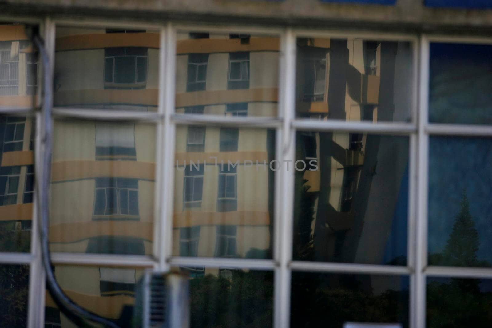 salvador, bahia / brazil - september 23, 2015: reflections of the street are seen in a mirrored building in the city of Salvador.