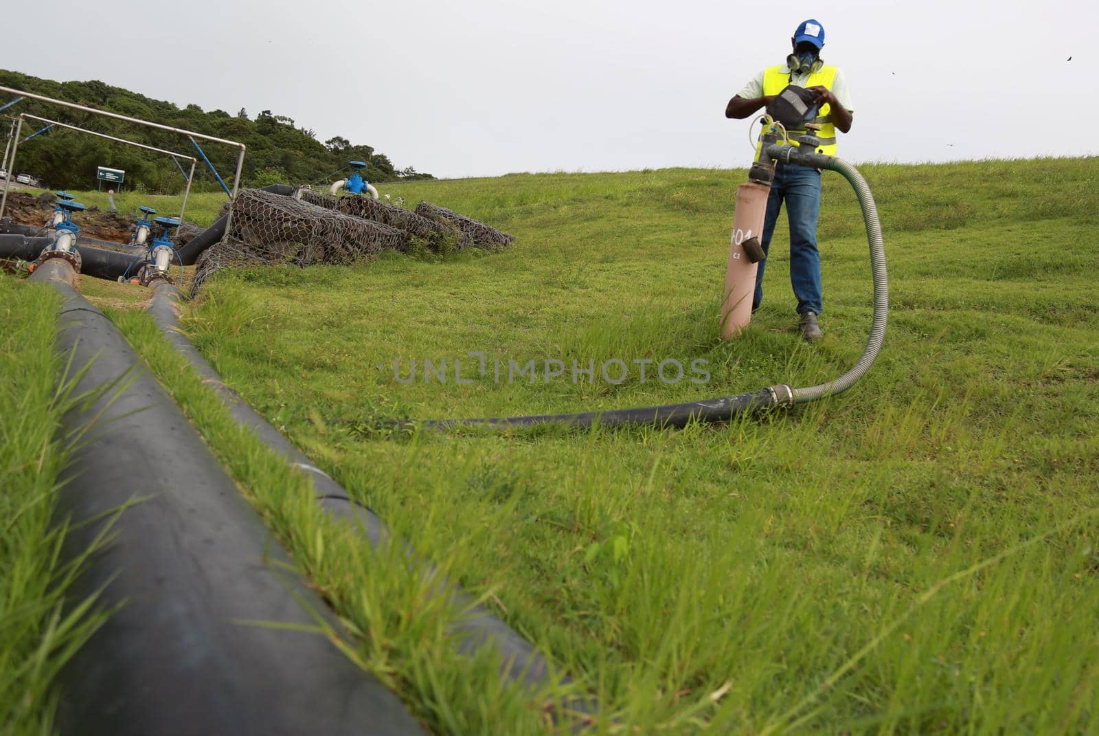 salvador, bahia / brazil - july 15, 2015:  Landfill employee measures methane gas produced on site. The product is used as fuel from a thermoelectric power plant.