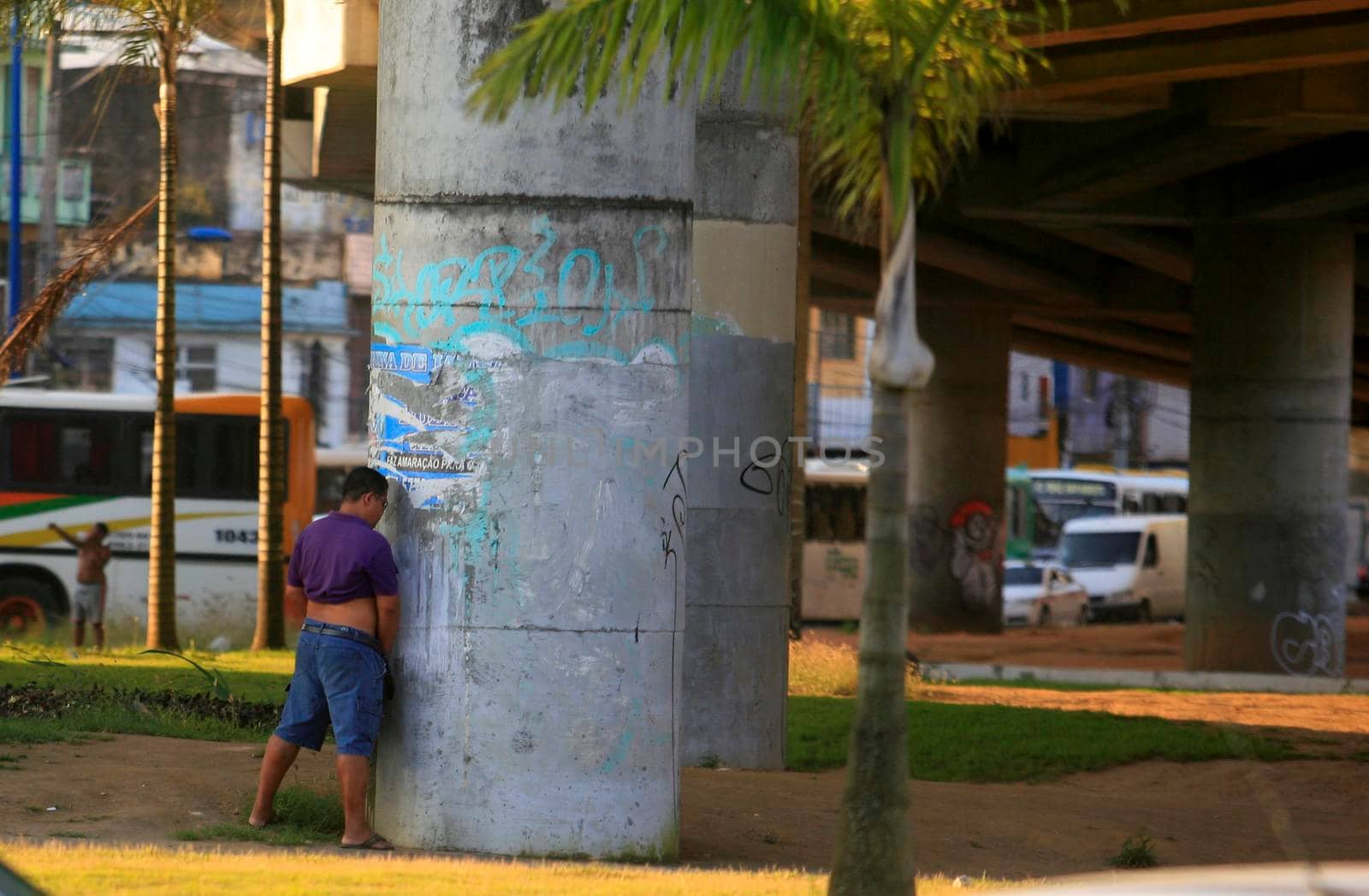salvador, bahia / brazil - september 23, 2015: Man is seen urinating on a viaduct pilaster in the city of Salvador.