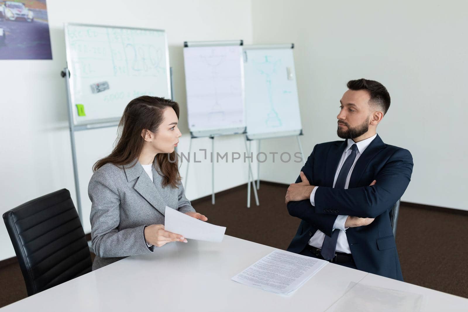 meeting in the meeting room of two company employees in business suits.