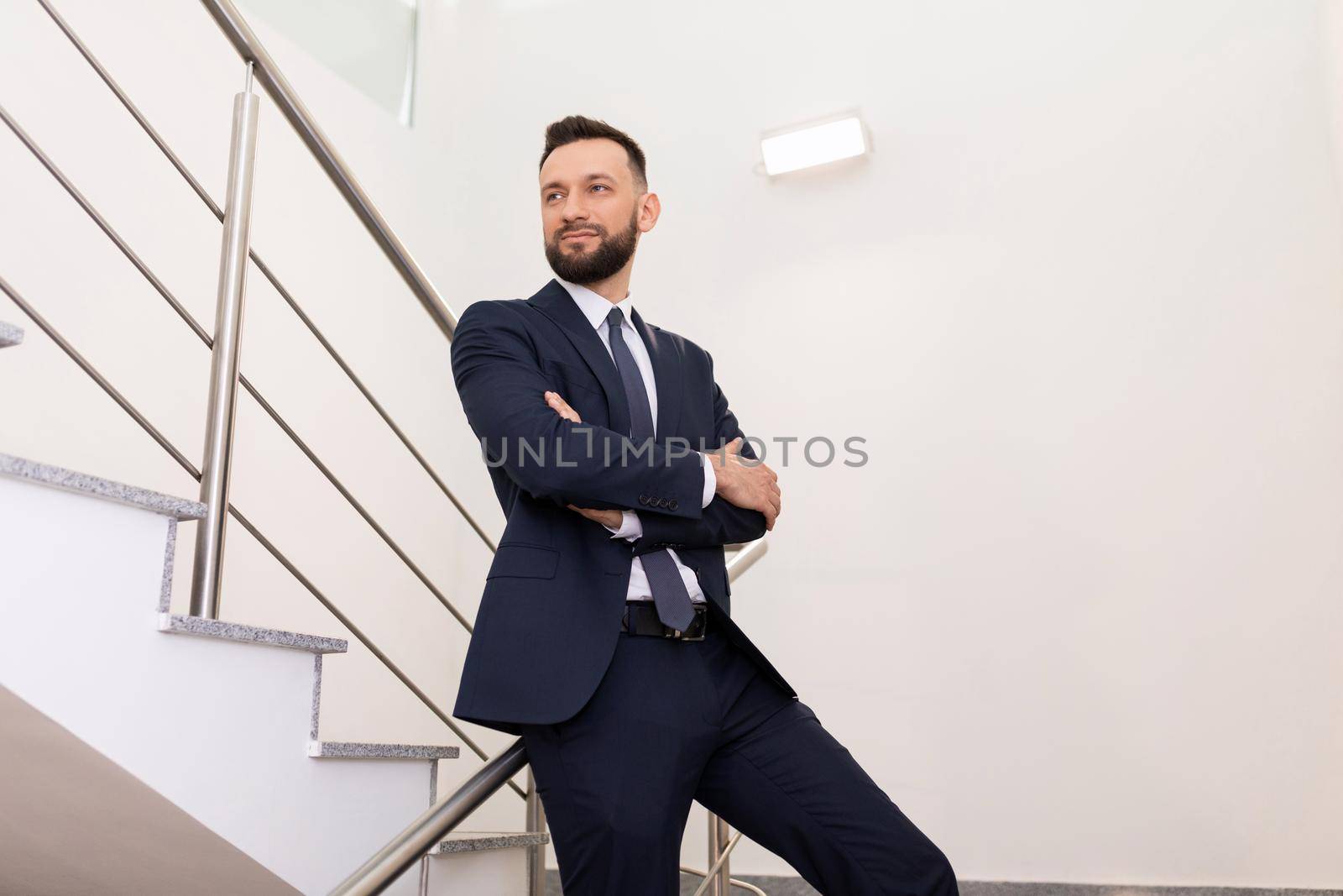 business portrait of a man in an office suit on the landing. Career growth concept.