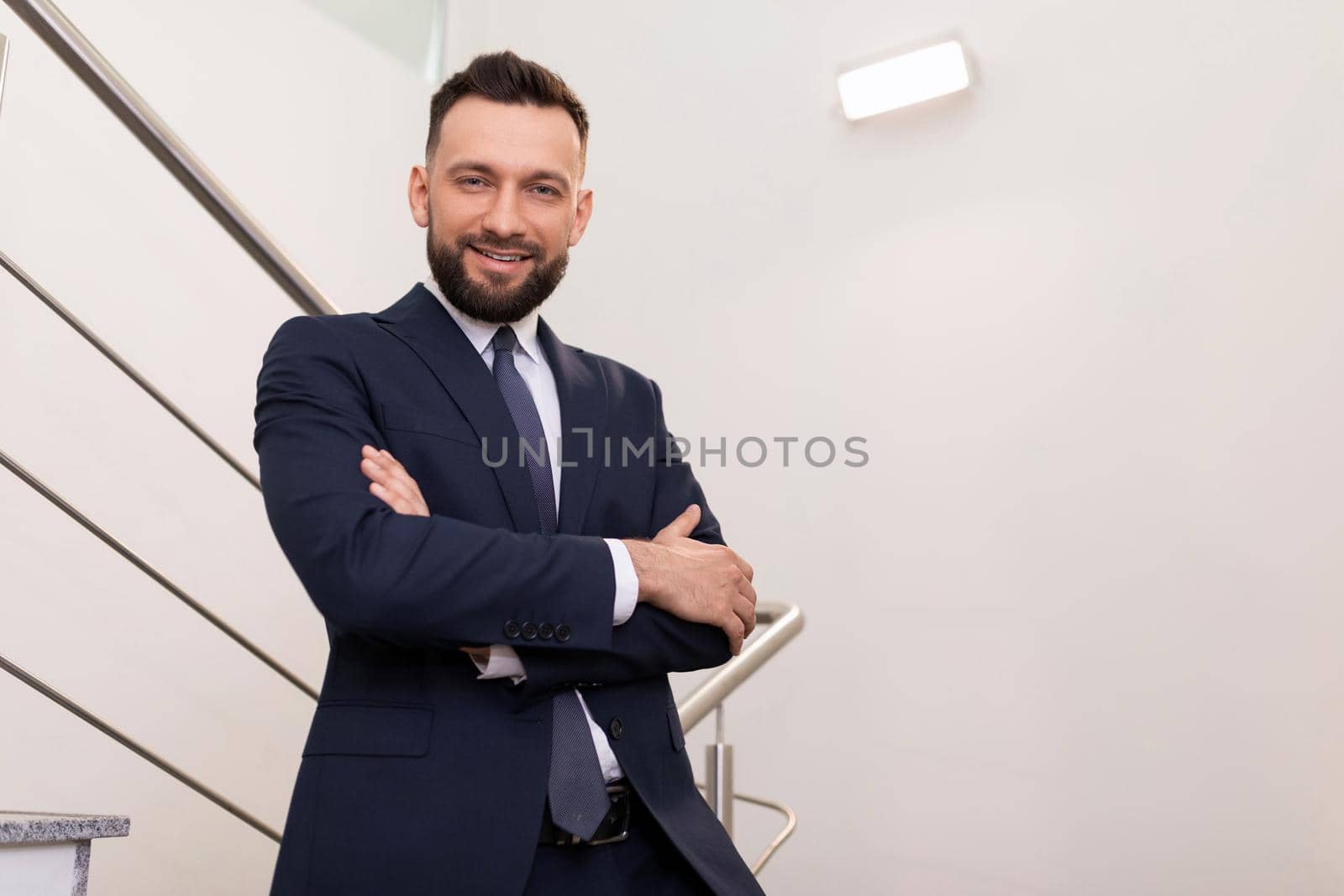 portrait of a middle-aged business man with crossed arms on his chest.