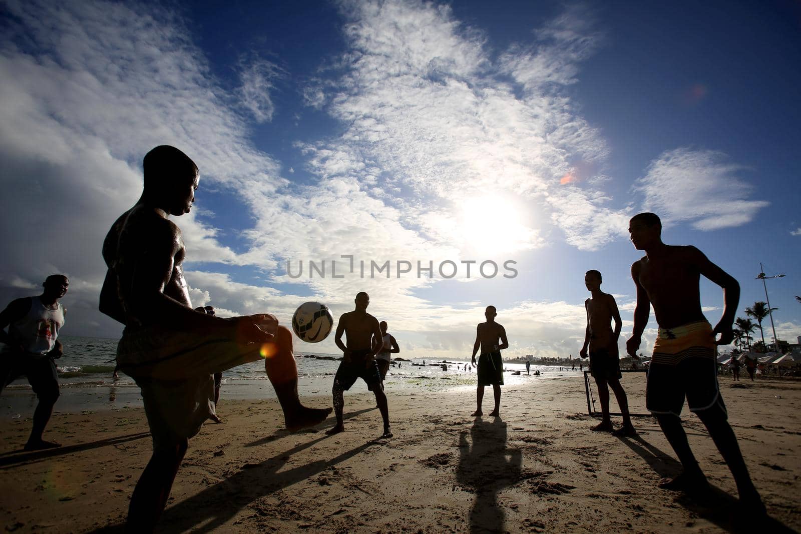 salvador, bahia, brazil - december 22, 2015: Young people are seen playing soccer on Itapua Beach in Salvador