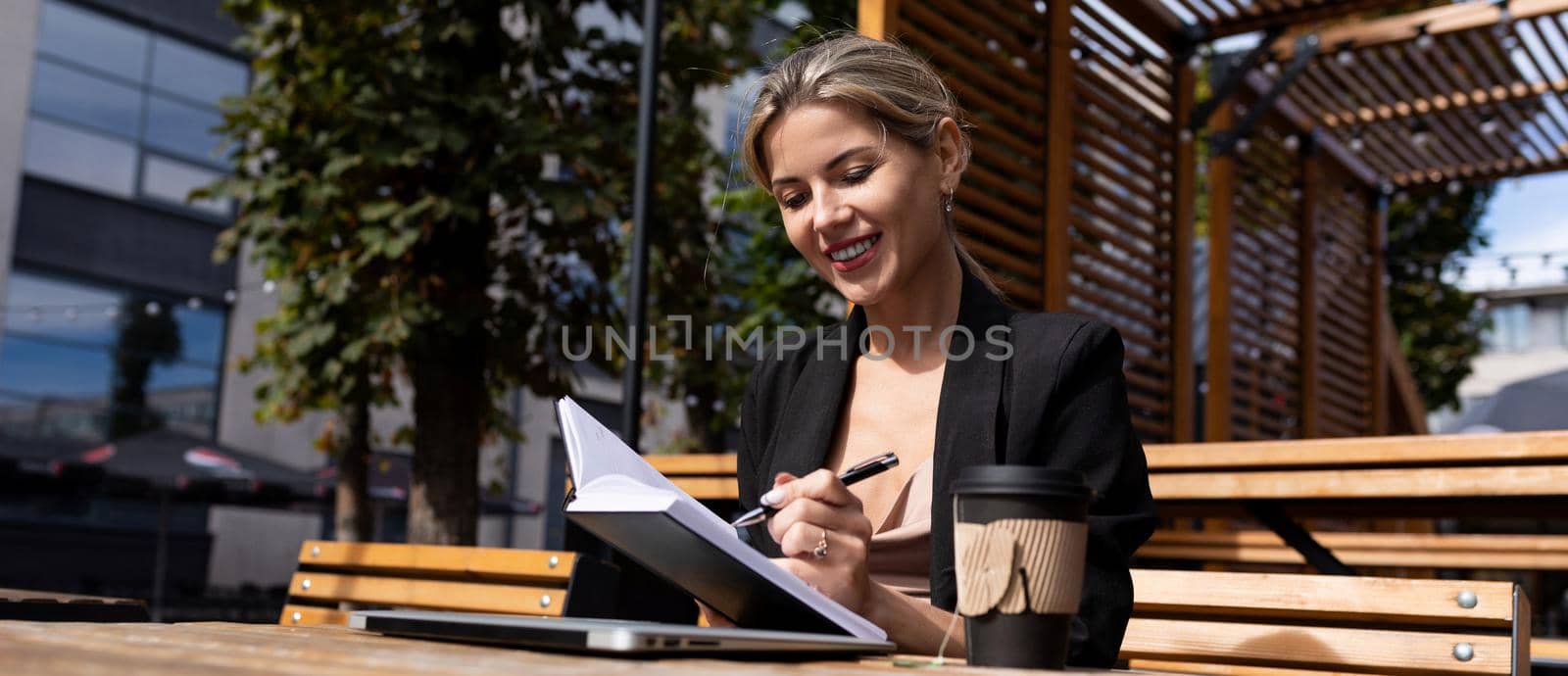 portrait of successful cafe business woman with diary.