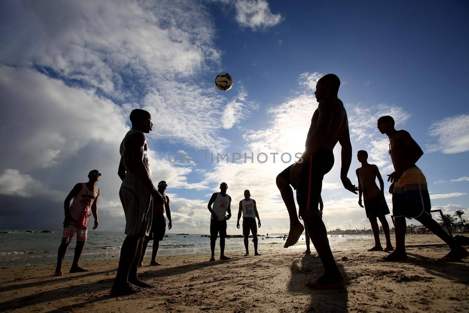 salvador, bahia, brazil - december 22, 2015: Young people are seen playing soccer on the sand of Itapua beach in the city of Salvador.