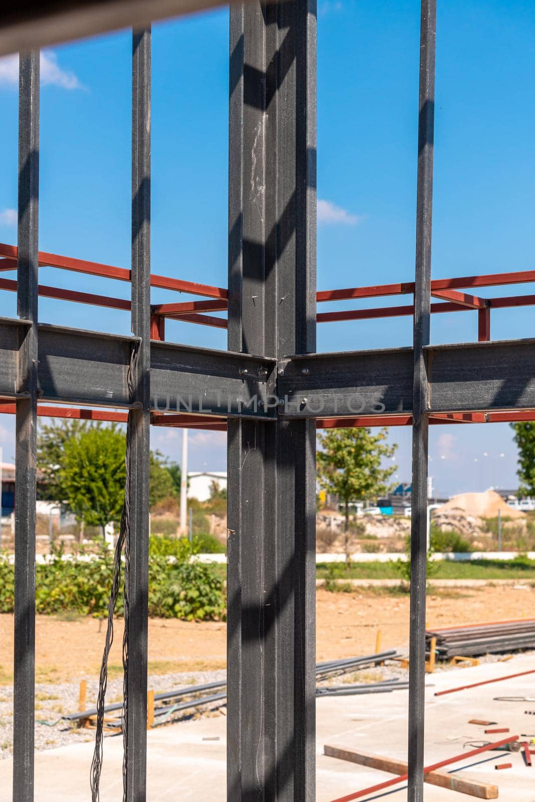 Structural steel beam connections, metal column supporting the roof construction. Structural steel concept by Sonat