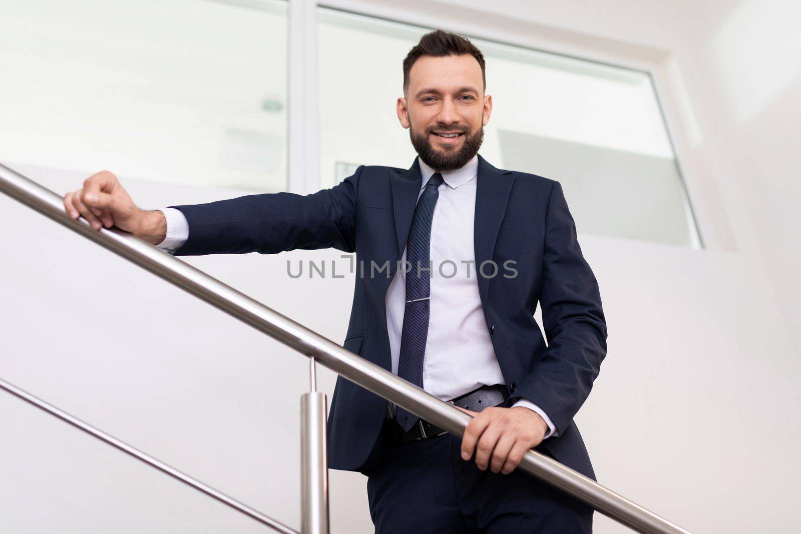 presentable head man in a business suit on the stairs bottom view.