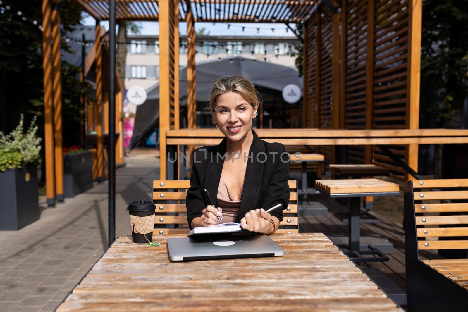 woman head working outdoors with laptop diary.