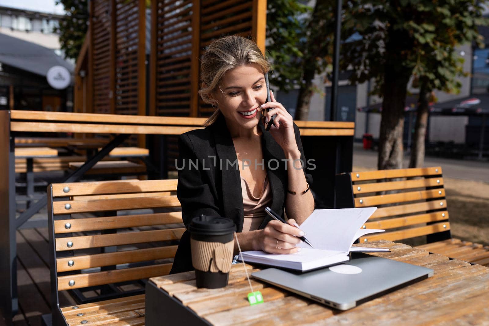 portrait of a successful young woman working in a cafe with a laptop.