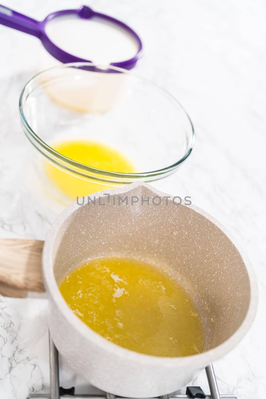 Melted sticks of unsalted butter on the counter.