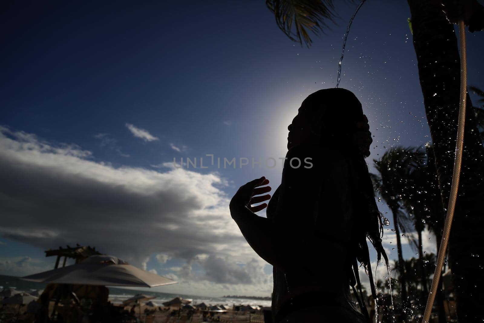 salvador, bahia / brazil - december 22, 2015: Woman taking a shower in Placafor beach in Salvador.