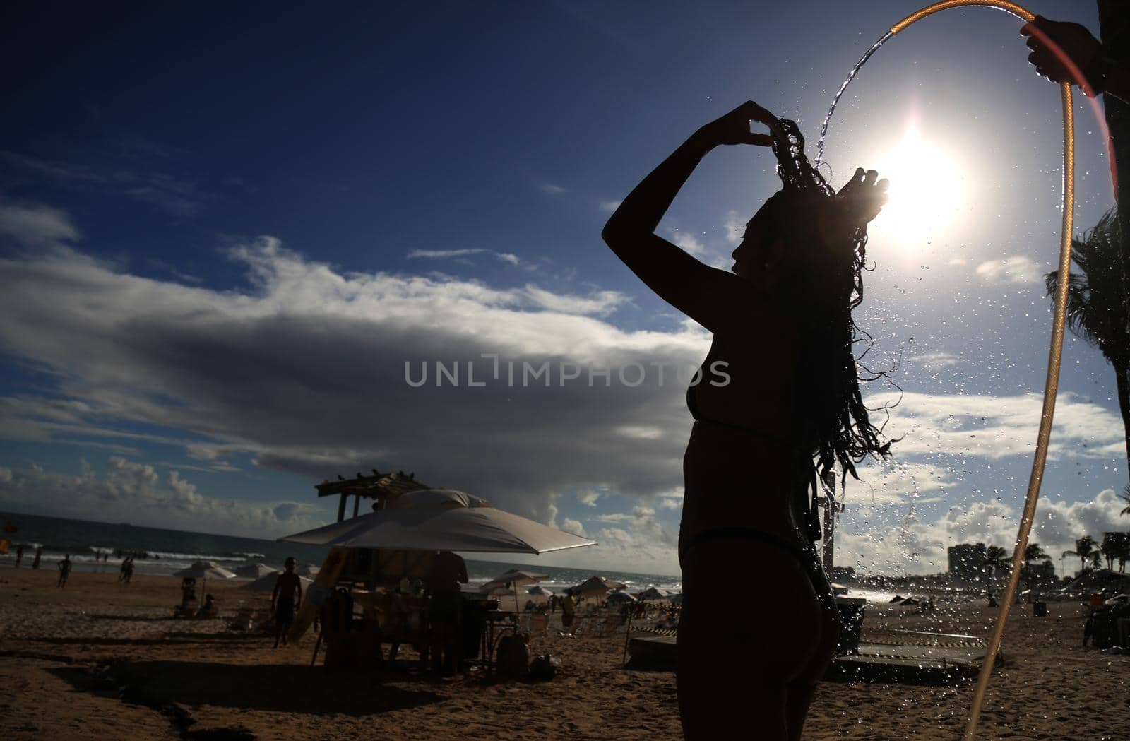 salvador, bahia / brazil - december 22, 2015: Woman taking a shower in Placafor beach in Salvador.