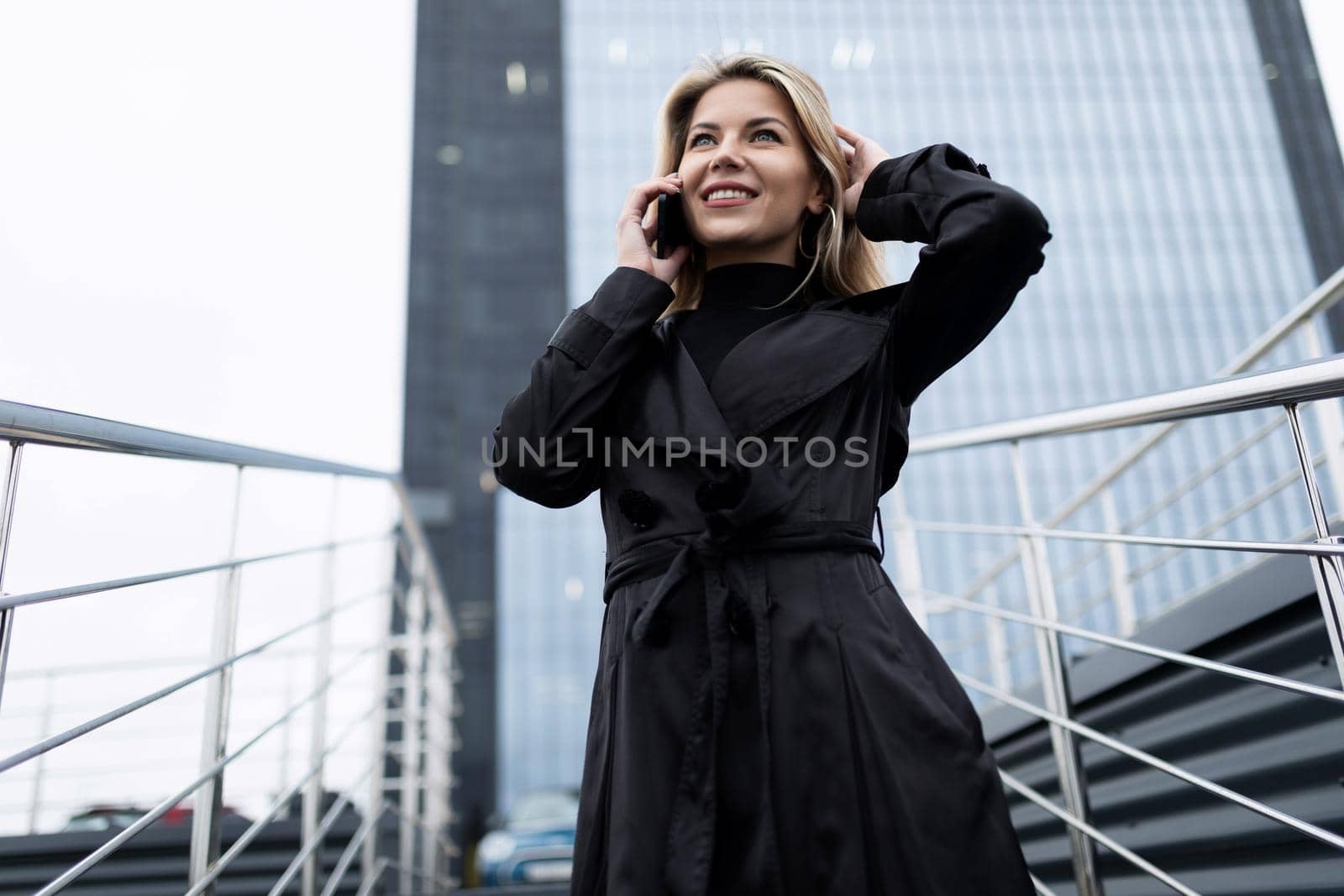portrait of a successful woman head of a middle-aged businessman against the backdrop of an office skyscraper.