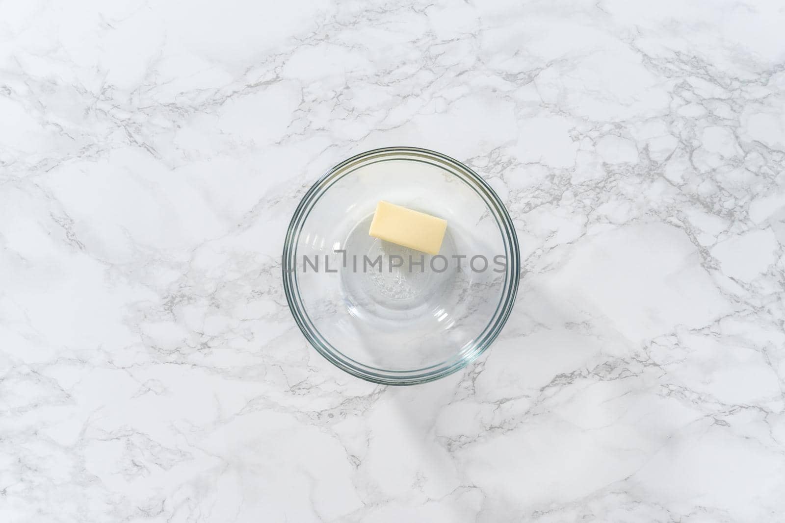 Flat lay. Melting stick of unsalted butter in a microwave.
