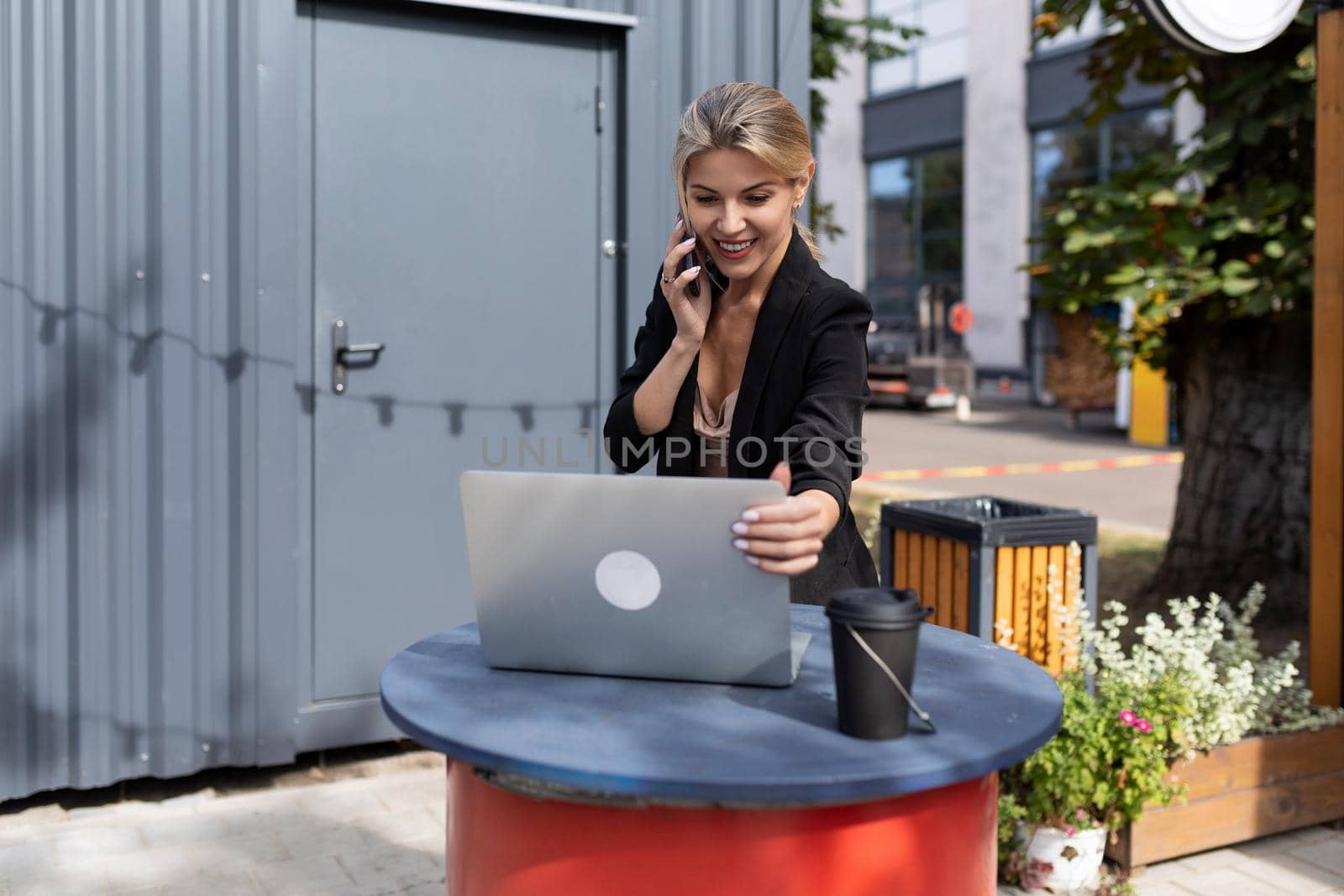 portrait of a successful young woman working in a cafe behind a laptop.
