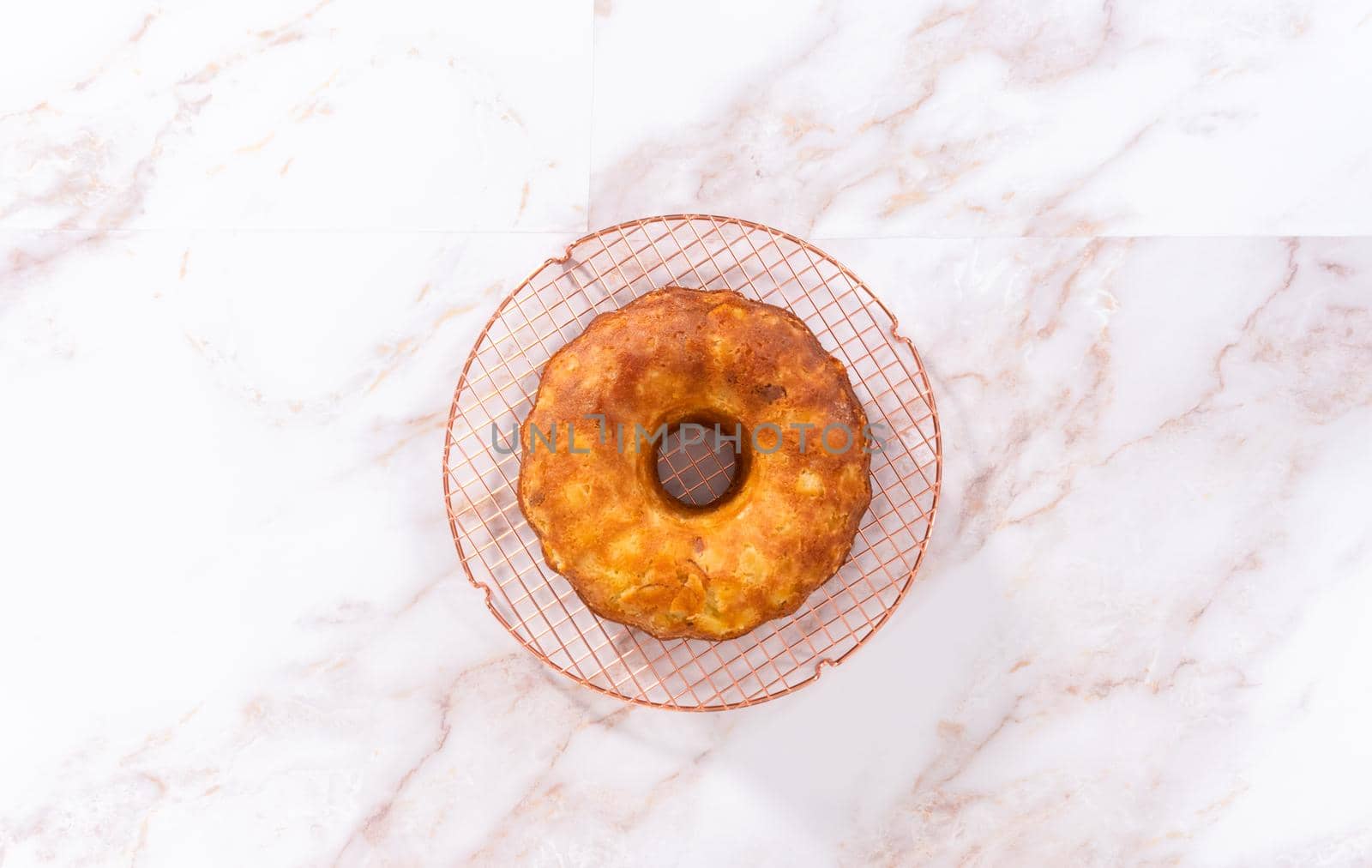 Flat lay. Cooling freshly baked apple bundt cake on a kitchen counter.