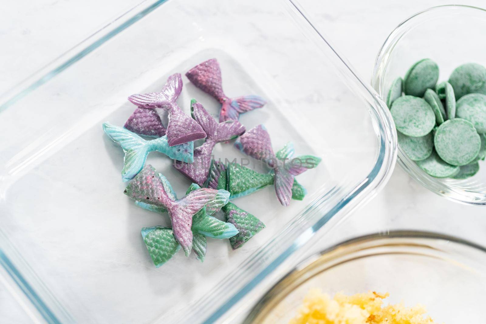 Measured ingredients in glass bowls to prepare mermaid cakesicles.