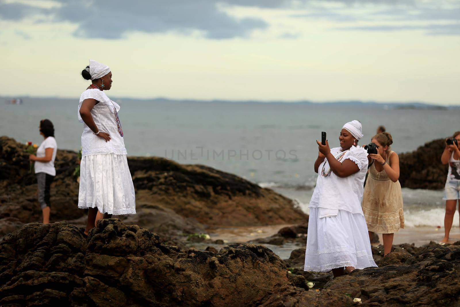salvador, bahia / brazil - february 2, 2020: devotees and admirers of the orixa yemanja, a candomble entity, seen on the rio Vermelho beach, in the city of salvador, during a religious celebration.
