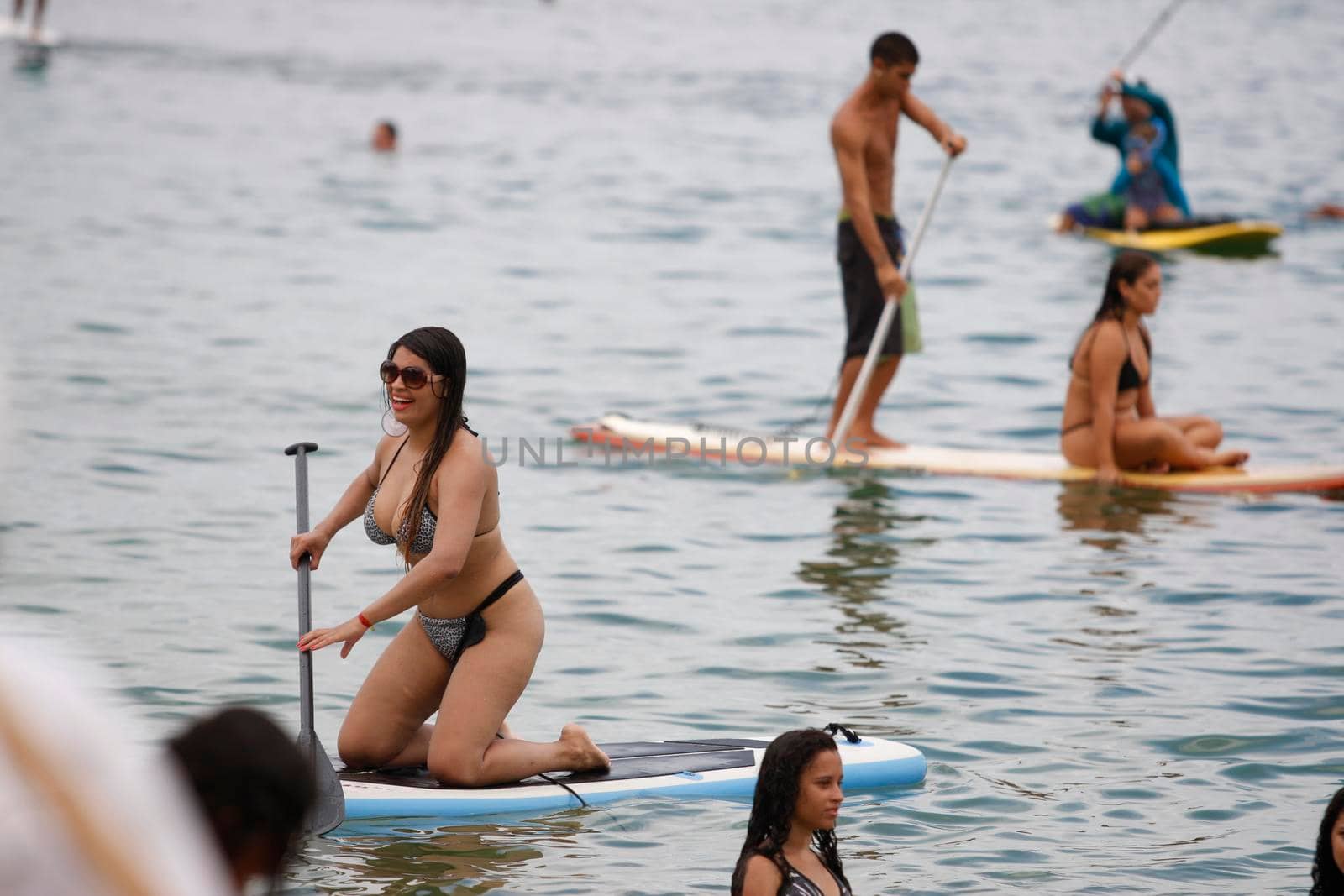 salvador, bahia / brazil - february 21, 2016: People are seen practicing stand up pedal on the beach of Porto da Barra, during the summer of the city of Salvador.