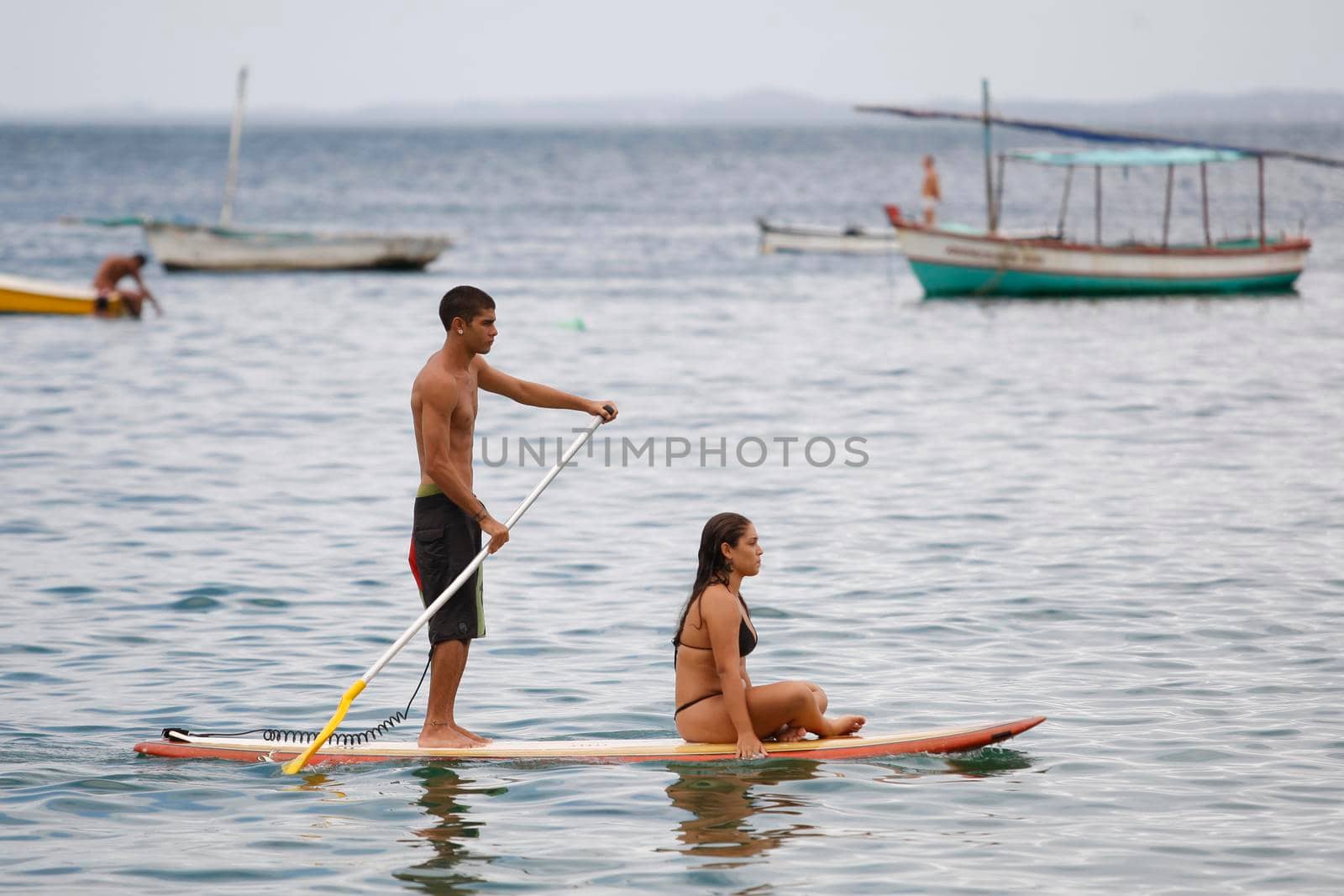salvador, bahia / brazil - february 21, 2016: People are seen practicing stand up pedal on the beach of Porto da Barra, during the summer of the city of Salvador.