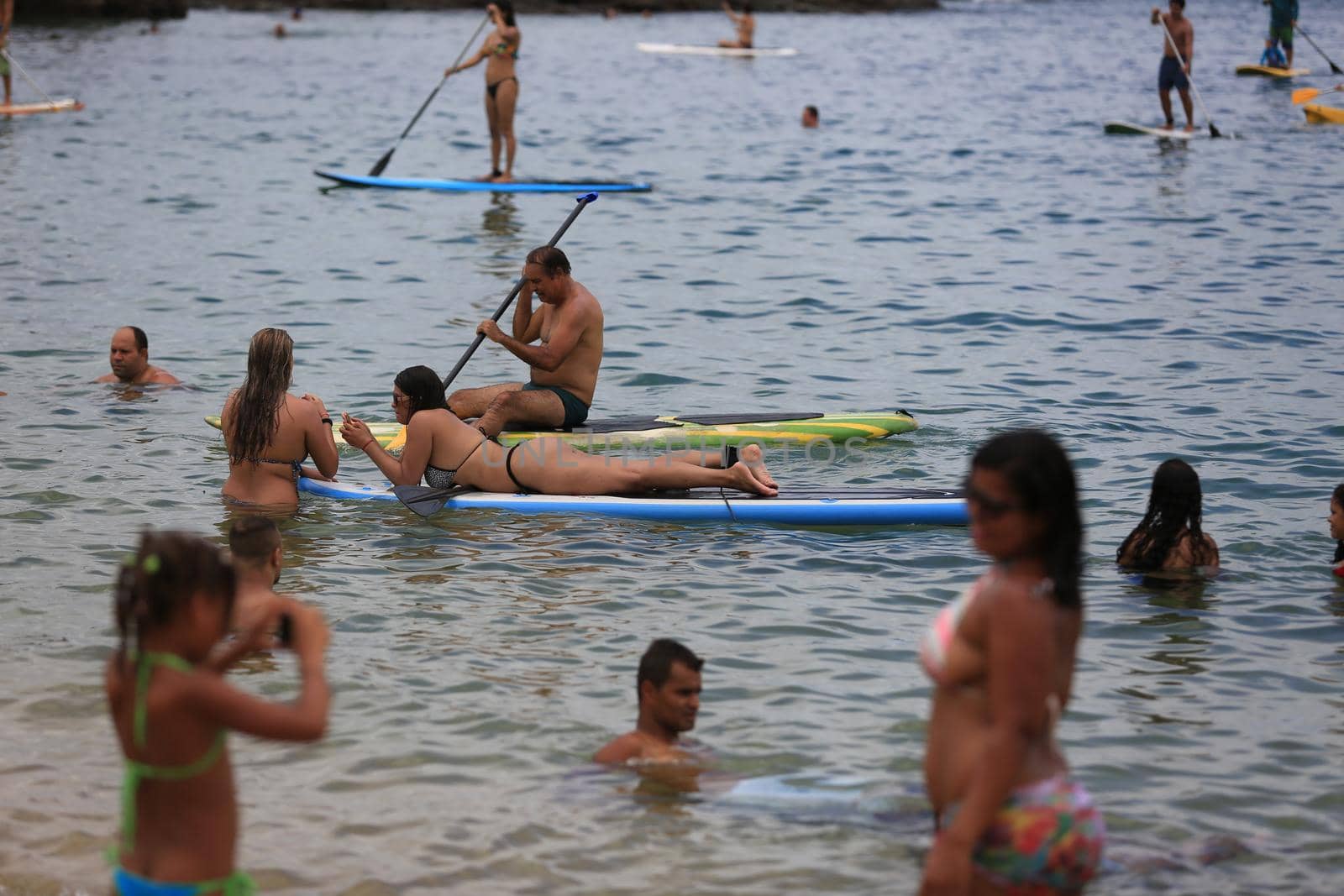 salvador, bahia / brazil - february 21, 2016: People are seen practicing stand up pedal on the beach of Porto da Barra, during the summer of the city of Salvador.