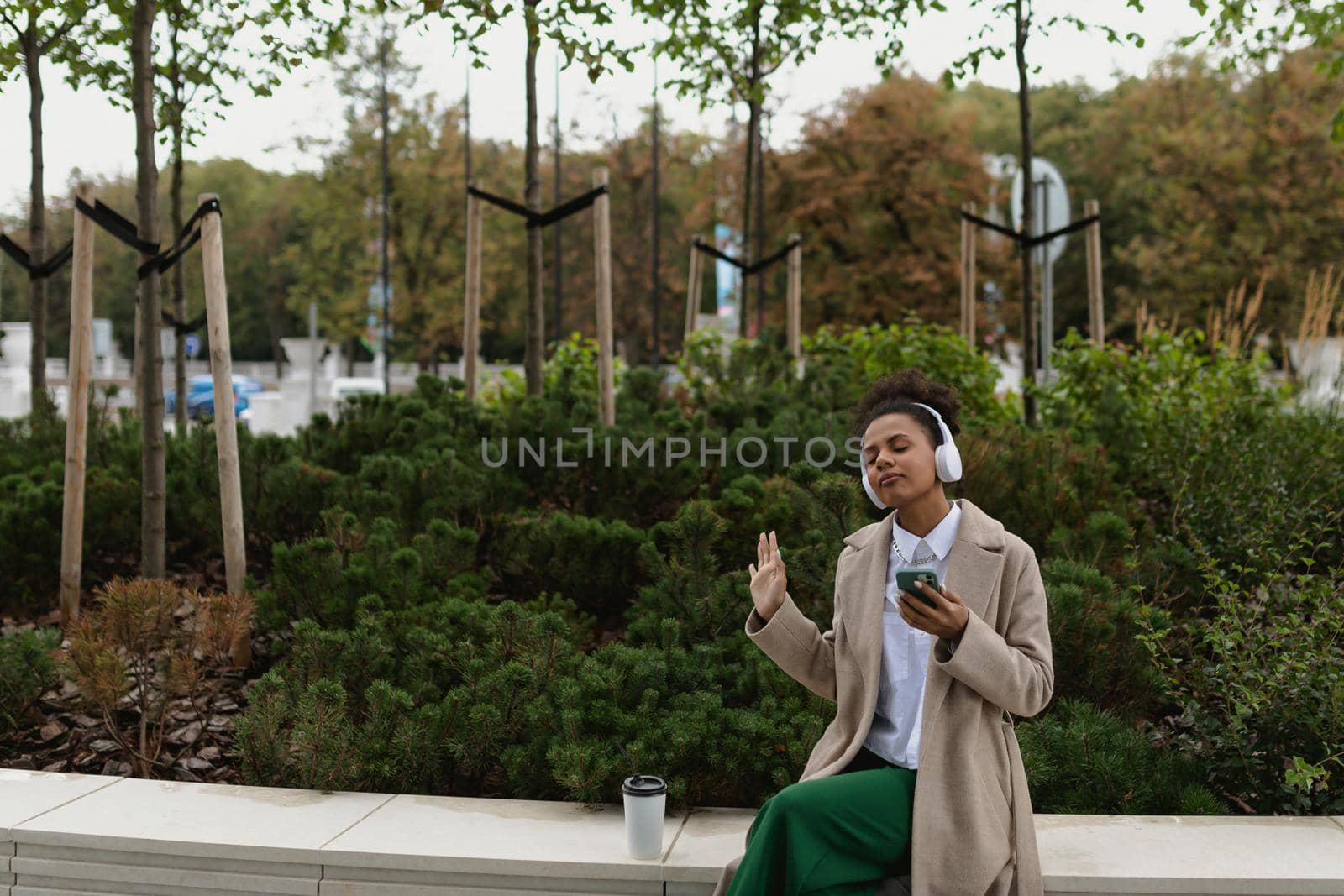 young black woman listening to music with headphones.