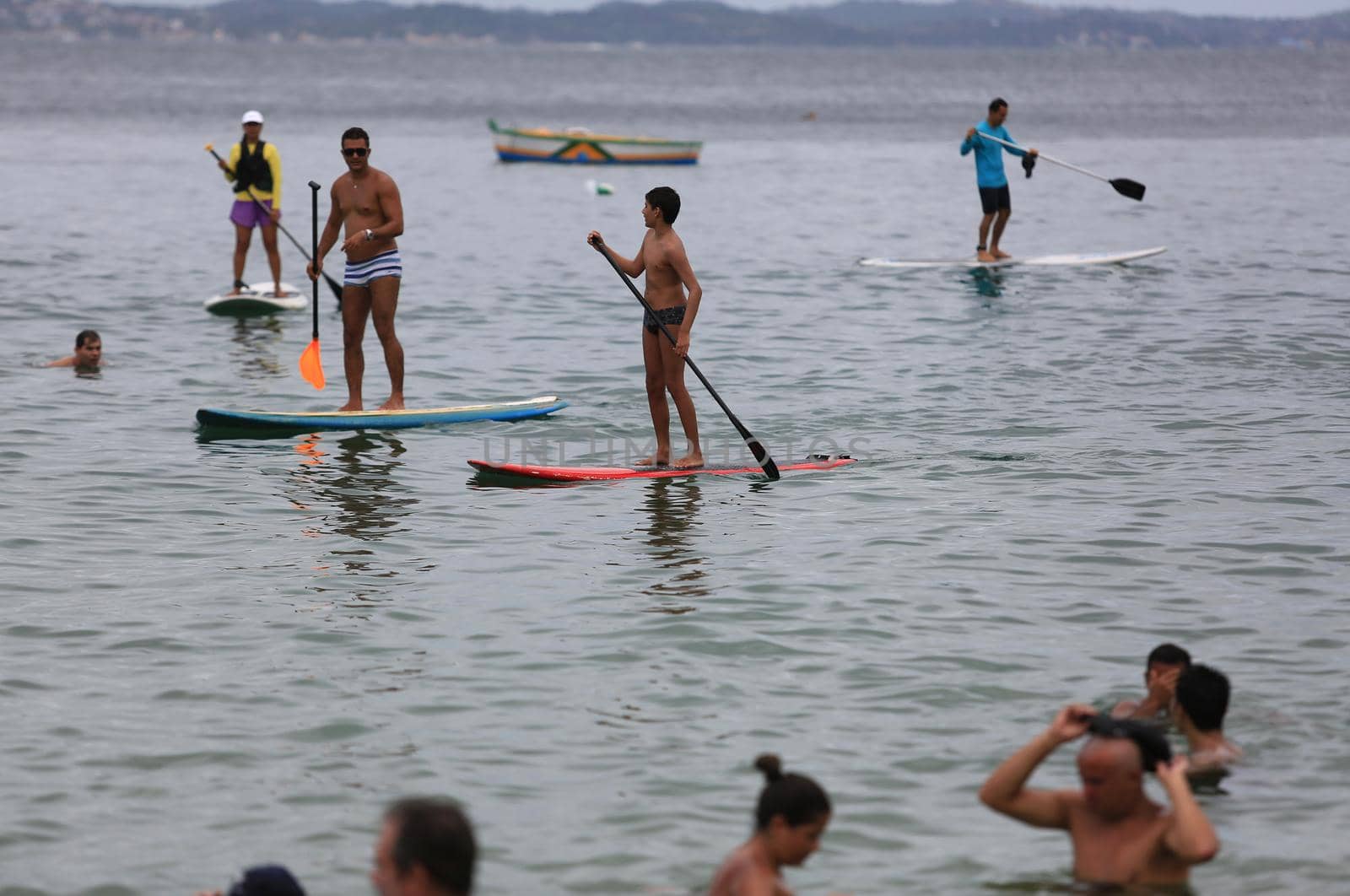salvador, bahia / brazil - february 21, 2016: People are seen practicing stand up pedal on the beach of Porto da Barra, during the summer of the city of Salvador.