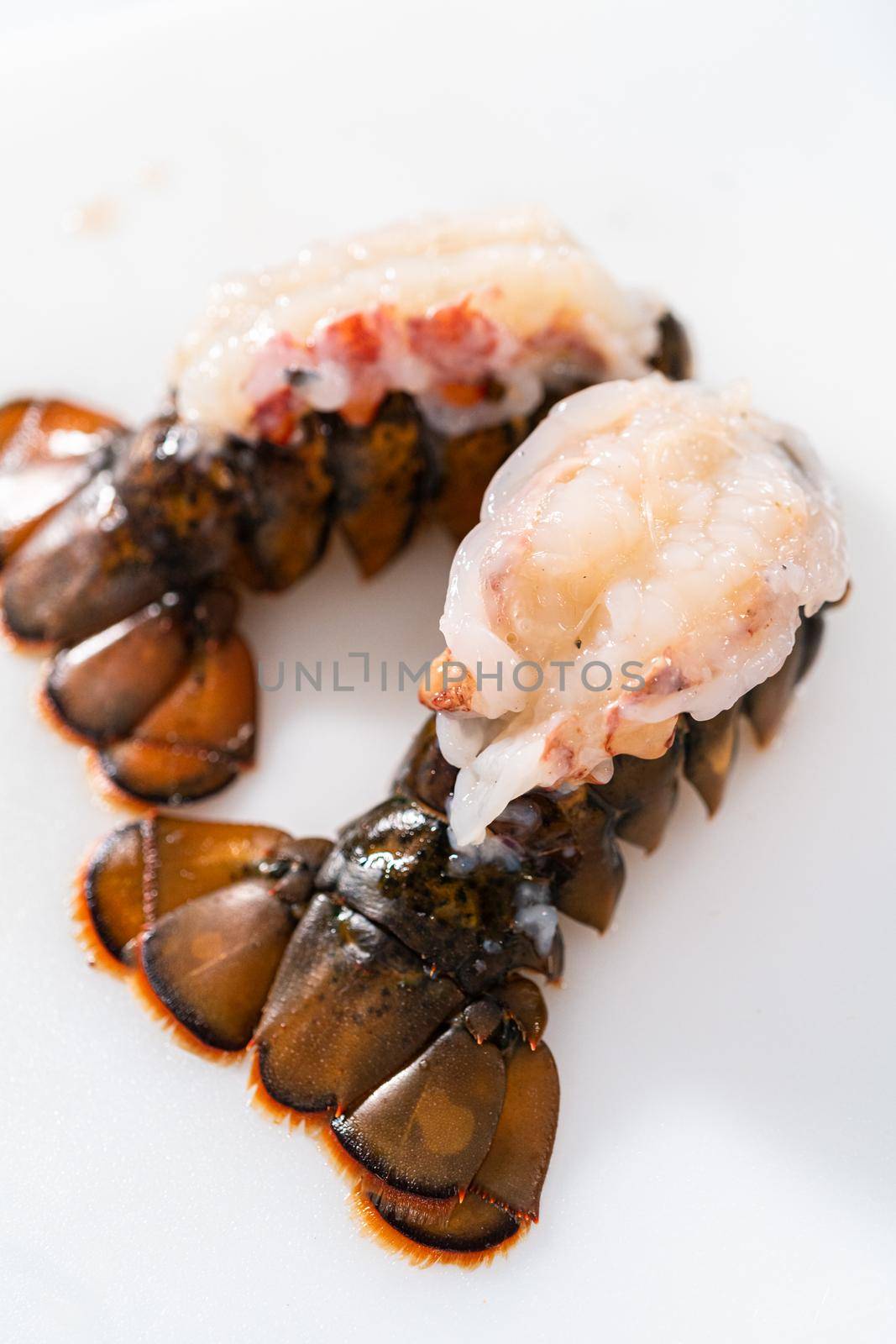Preparing raw lobster tails to make garlic lobster tails.