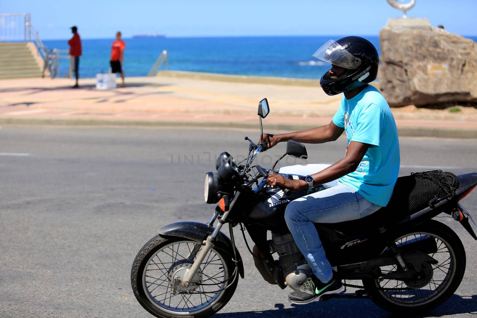 salvador, bahia / brazil - august 10, 2016: motorcyclist is seen wearing helmet while traveling with his motorcycle in the city of Salvador.