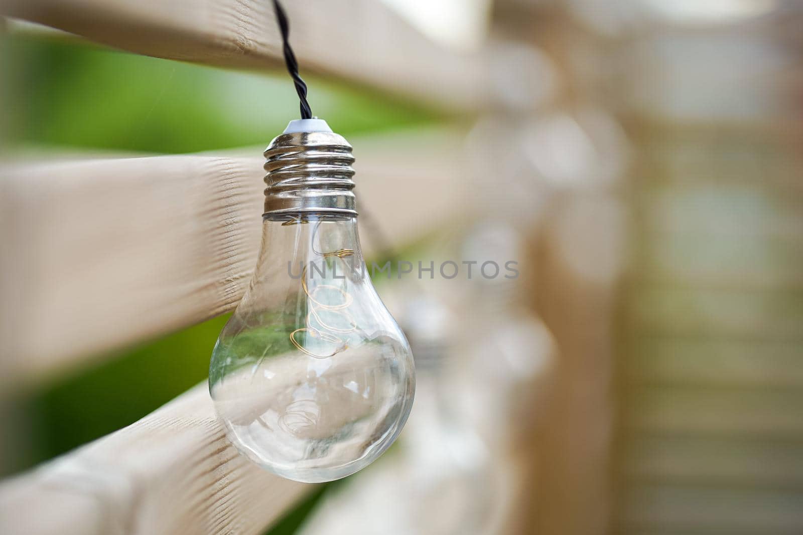 Close up picture of LED sun powered bulb on the wooden wall