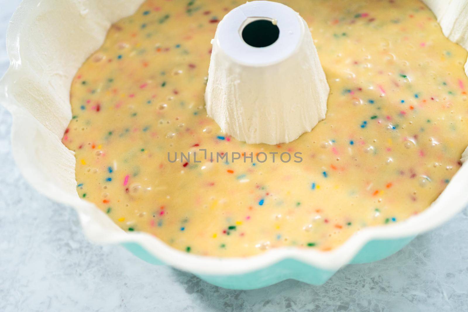 Close up view. Cake batter in a bundt cake pan to bake funfettti bundt cake.