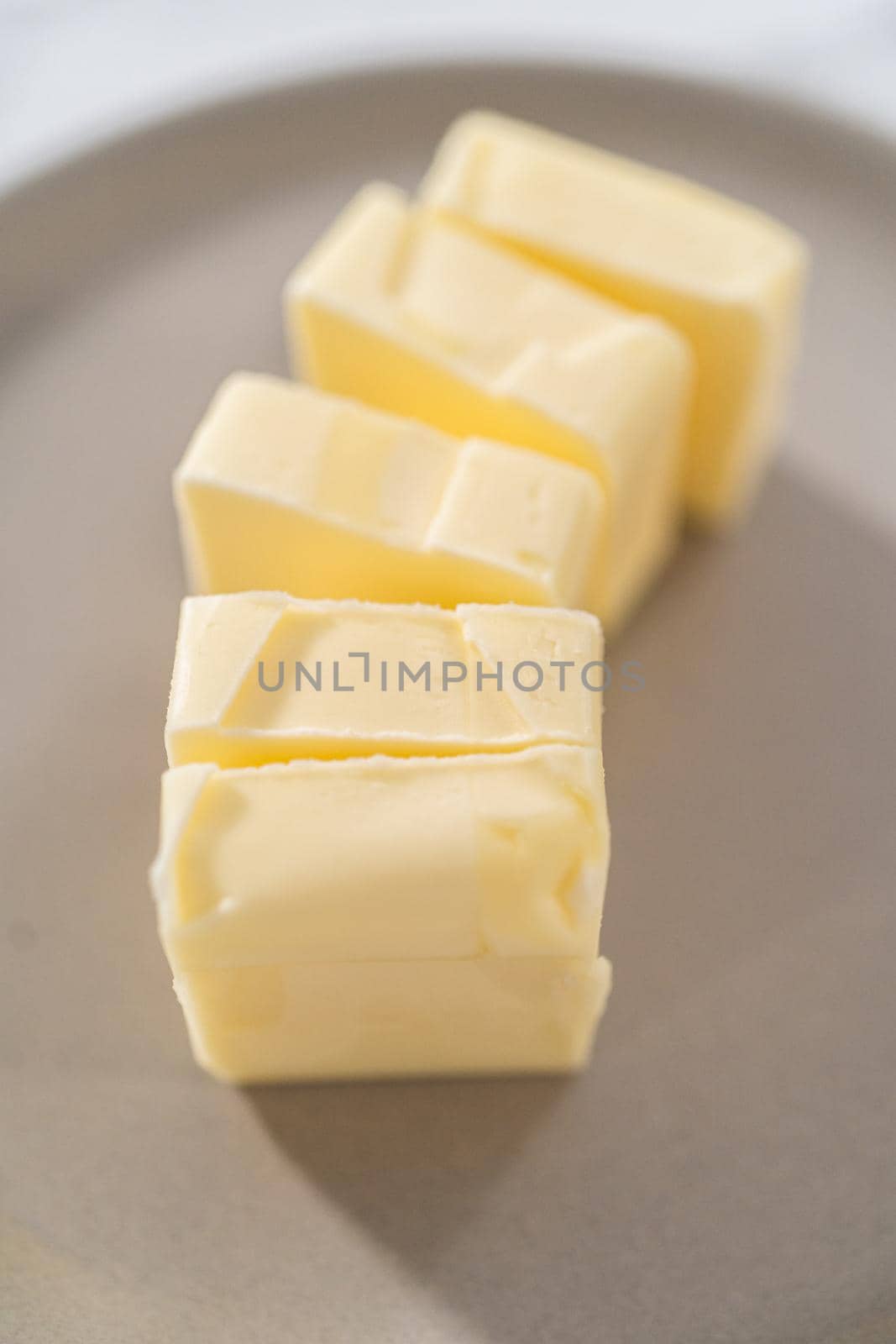 Softened sticks of unsalted butter on the kitchen counter.